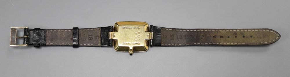 A gentlemans stylish modern silver gilt Dunhill quartz wrist watch, with rectangular Roman dial, on leather strap, with Dunhill buckle